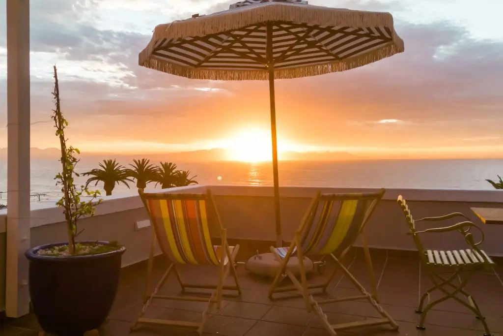 Sunset from the private balcony at Bliss Seaside Apartment overlooking False Bay.